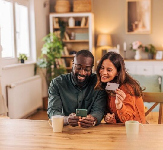 Couple with CC and Cellphone at table