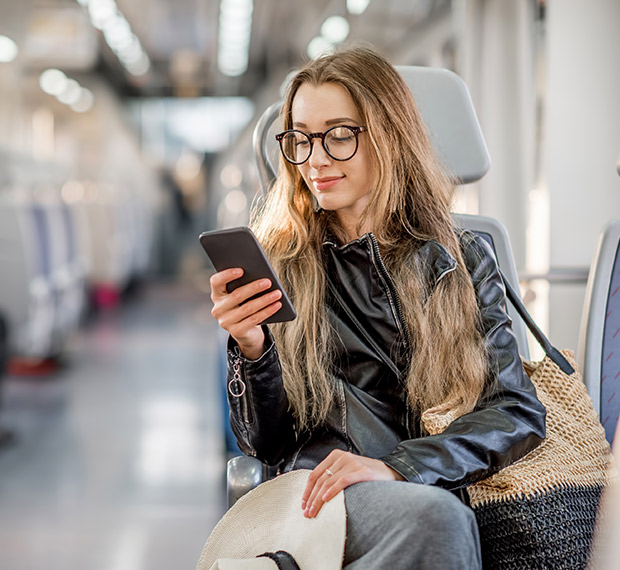 Woman using her phone while on public transit